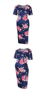Detail view of navy blue maternity dress featuring floral print and side ruching