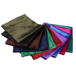 Set of ten colorful solid satin square scarves with a glossy silk-like finish on white background