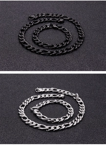 Detail of classic Cuban link chain sets in polished silver and black stainless steel