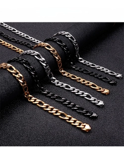 Close-up of cuban and figaro chains in gold, silver and black with lobster clasps