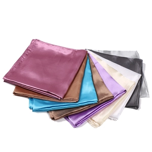 Detail shot of multi-color satin silk square scarves with high-gloss finish and smooth texture