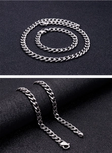 Detailed close-up and flat lay of a silver polished stainless steel Cuban link jewelry set