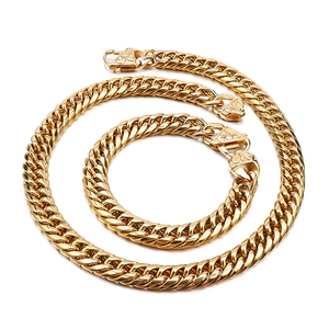 Bold gold-plated stainless steel Cuban link necklace and bracelet set for men on white background