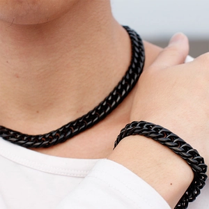 Men's bold black stainless steel Cuban link necklace and bracelet jewelry set on model