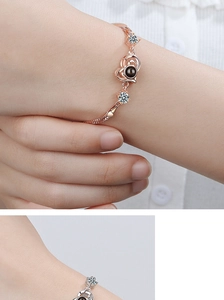 Detail of rose gold and silver heart projection bracelets with cubic zirconia stones