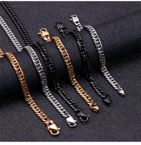 Detail shot of 9mm Cuban link chains in gold, silver, and black finishes on dark stands
