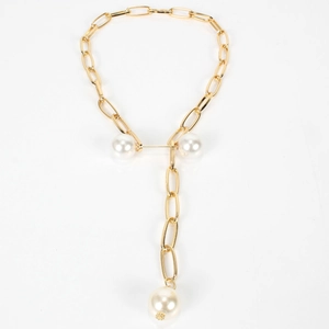 Close-up of golden Y-shaped necklace with industrial link chain and three large white pearls