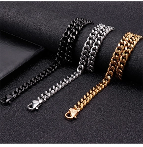 Three men's Cuban link chains in black, silver, and gold finish over dark textured surface