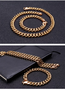 Detailed view of gold Cuban link chain set with lobster clasp on a dark background