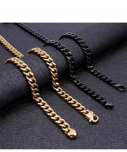 Detail of gold and black Cuban link chains with intricate vintage textured clasps