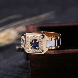 Luxurious men's blue gemstone ring in two-tone gold and silver on a wooden box