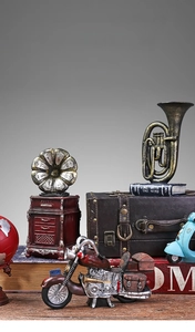 Close-up of vintage red motorcycle model and retro music instruments home decor
