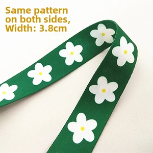 Detail view of 3.8cm dark green canvas strap with white daisy pattern on both sides