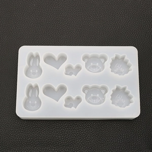 Detail of 8-cavity white silicone mold with rabbit, bear, and heart shapes for resin DIY