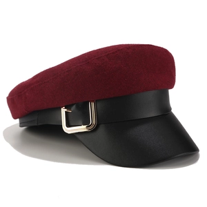 Detail of burgundy and black newsboy cap featuring side golden square metal buckle