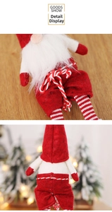 Detail of a Christmas gnome featuring striped legs, felt fabric, and white fiber beard