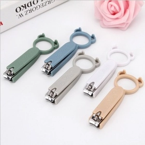 Close-up of cute cartoon nail clippers with frosted handles and convenient finger rings