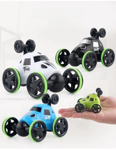 Hand holding four colorful mini stunt cars to show compact pocket-sized portable dimensions
