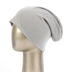Detail of light gray slouchy beanie showing soft knit texture on metallic head model
