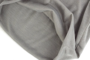 Detailed macro view of light gray knitted fabric texture showing fine weave and softness