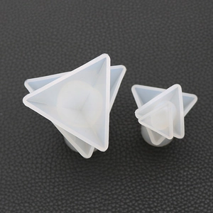 Detail view of large and small triangular pyramid silicone molds for resin casting