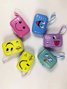 Detailed view of colorful mini suitcase coin purses with cute smile faces and lanyards