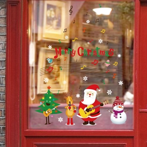 Festive Christmas Santa Claus and reindeer window stickers on a red wood glass door