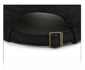 Detail of adjustable metal buckle on dark blue twill cotton baseball cap