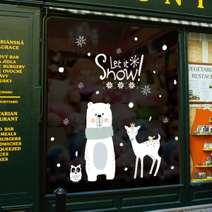 Christmas window decals with bear, deer, and snowflakes on glass with Let it Snow text