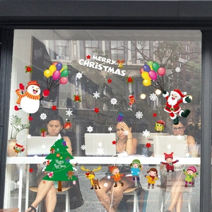 Merry Christmas and Happy New Year decals with Santa Claus and reindeer on a window