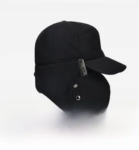 Detail of winter trapper hat featuring windproof fabric, faux fur lining and metal snaps