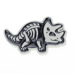 Macro detail of triceratops skeleton brooch pin in black and white finish