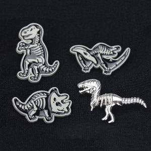 Detailed set of four dinosaur skeleton enamel brooches featuring T-Rex and Triceratops