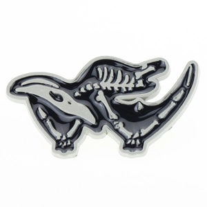 Detail view of the silver dinosaur skeleton brooch with black enamel inlay and metal lines