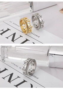 Detailed view of crown ring with star accents and inlaid zircon in gold and silver