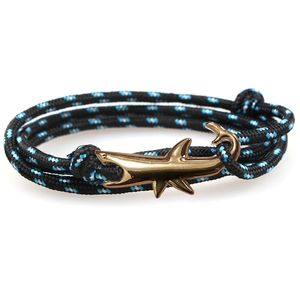 Fashionable braided nylon rope bracelet with golden shark metal buckle on white background