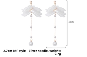 Détail de boucles d'oreilles fleurs blanches avec perles et tiges en argent, 8cm