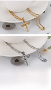 Detailed close-up showing gold and silver angel wing pendants with polished O-chains