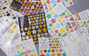 Detailed close-up of colorful gold foil alphabet and number stickers for DIY journaling