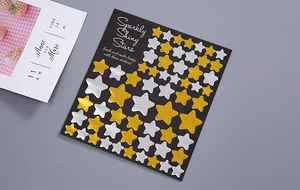 Close-up of gold and silver star stickers in various sizes for DIY craft decoration