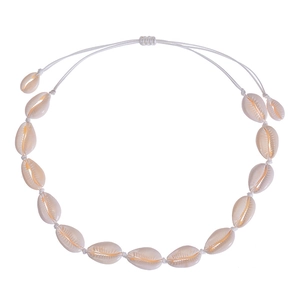 Detail of handmade bohemian shell necklace with white woven cord and adjustable closure
