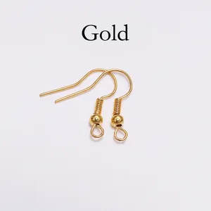 Close-up of gold-plated stainless steel fish hook earrings with spring and ball detail