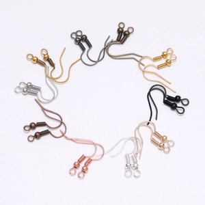 Various colored DIY earring hooks with beads and springs on a clean white background