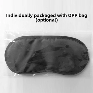 Close-up of black polyester sleep mask in individual clear OPP bag packaging
