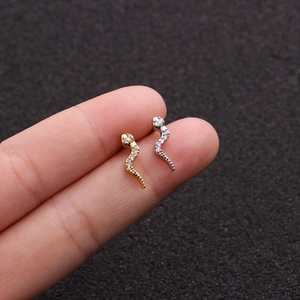 Detailed close-up of snake earrings in gold and silver finish with pave crystal inlay