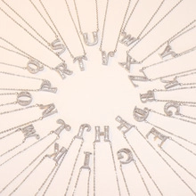 Radial display of silver letter necklaces from A to Z with sparkling zircon pavé