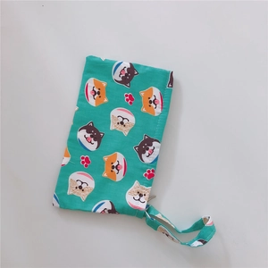 Detail of turquoise cotton bag with cute Shiba Inu dog patterns and a carry strap