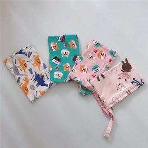 Detail of colorful cotton pouches with dinosaur, shiba inu and ballet girl patterns