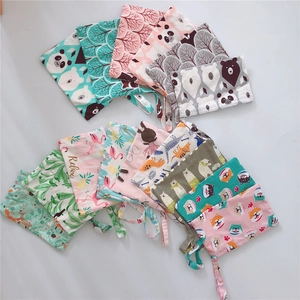 Close-up of various animal print cotton pouches with wrist straps for storage