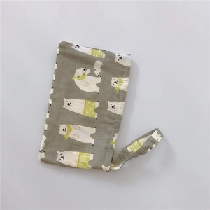 Close-up of khaki cotton phone pouch featuring a cute cartoon polar bear print with strap